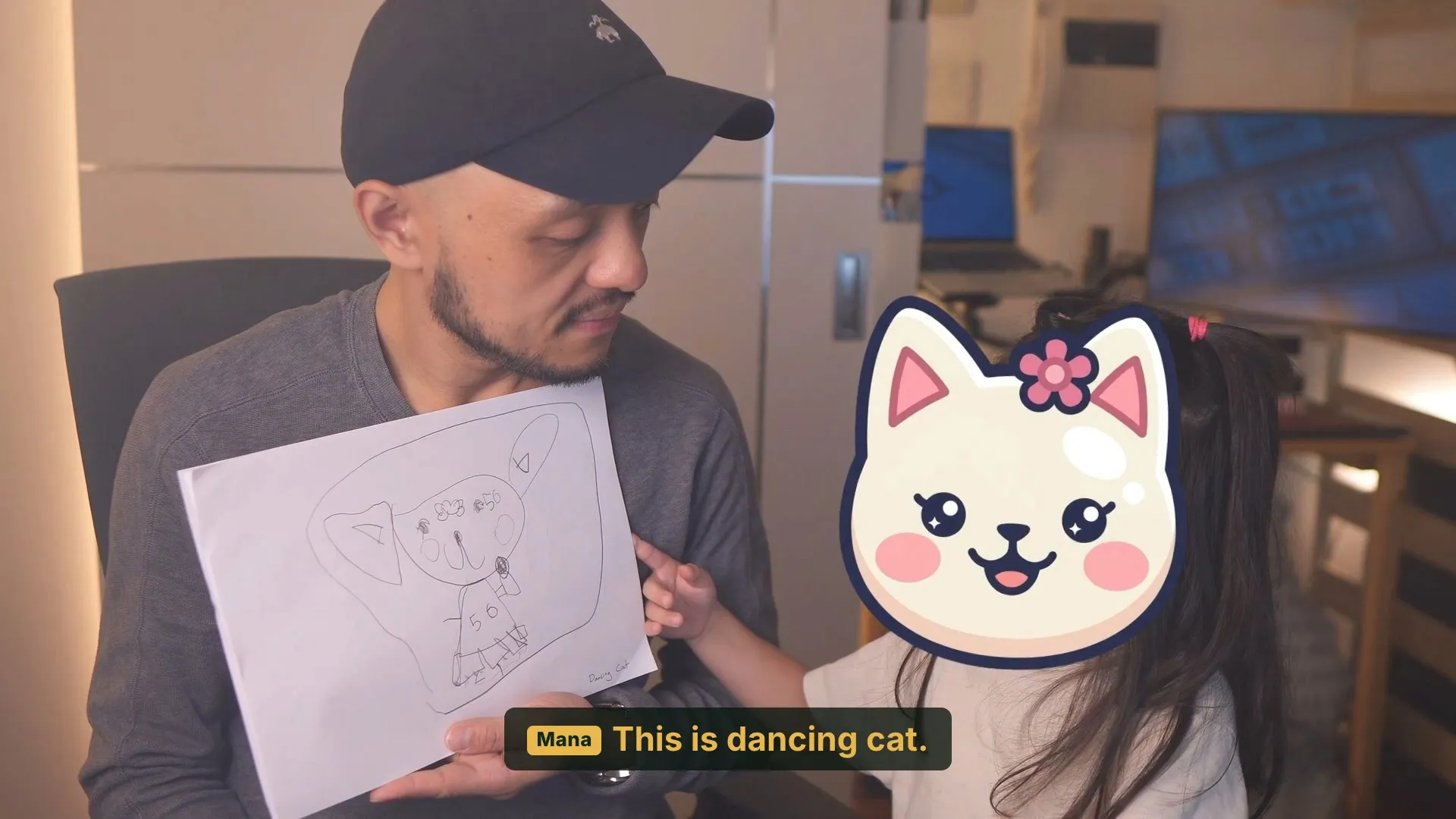 A five year old explaining her pencil drawing of Dancing Cat for the game we built with AI, face covered by a cartoon cat
